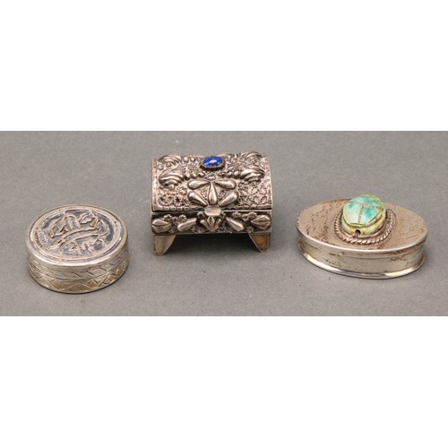 329 - An Egyptian silver oval box, of antiquities interest, the hinged cover set with a turquoise faience ... 