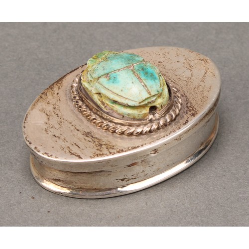 329 - An Egyptian silver oval box, of antiquities interest, the hinged cover set with a turquoise faience ... 