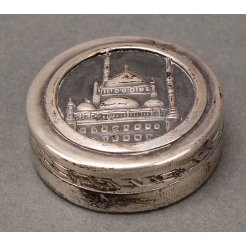 247 - An Egyptian silver circular box, the cover embossed with a view of the Mosque of Muhammed Ali, Cairo... 