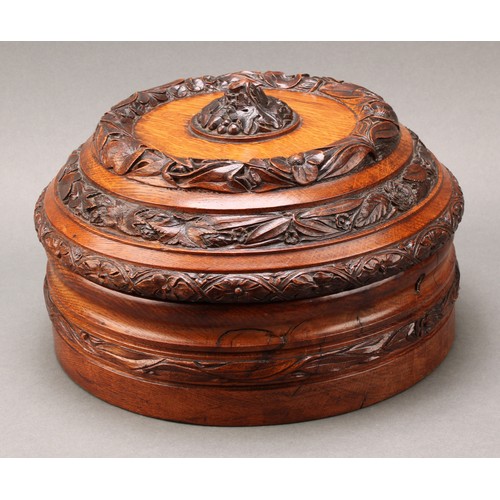 2117 - An unusual and substantial Victorian oak circular jewellery box, boldly carved with a leaf and acorn... 