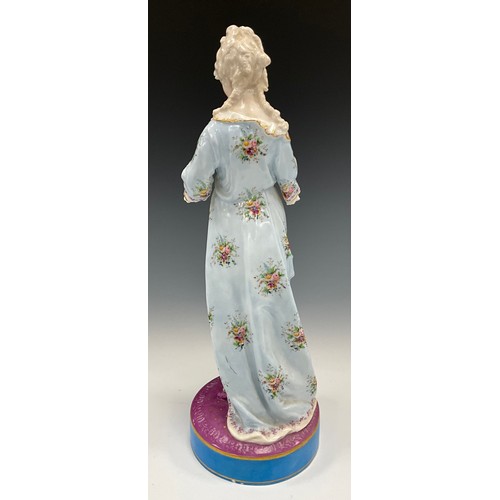 1184 - A 19th century continental porcelain figure of lady reading, hand painted and gilt detail, on purple... 