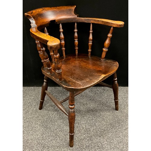 1558 - An Elm smokers’ bow armchair, well figured seat, of good colour, early 19th century.