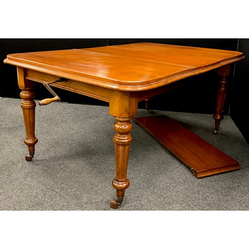 1697 - A Victorian mahogany extending dining table, the rounded rectangular top with moulded edge, turned a... 