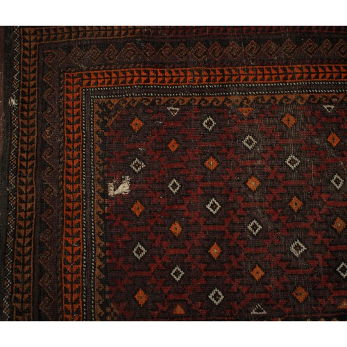 2063 - An Afghan Baluch woollen rug or carpet, 182cm x 101cm