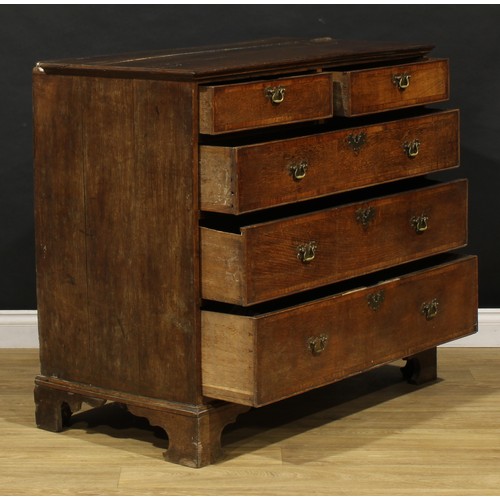 1780 - A George III oak chest, of two short and three long graduated mahogany crossbanded drawers, skirted ... 