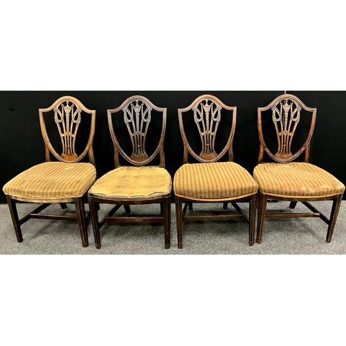 1925 - A set of four George III, Hepplewhite style chairs, shield-shaped backs, with carved urn and soaks s... 