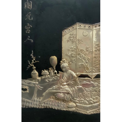 490 - A Chinese Electrotype or silver embossed panel Geisha seated at the tea table resting upon a rug, a ... 