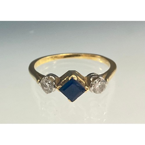 564 - A diamond and sapphire ring, central sqaure cut mid blue sapphire approx 0.12ct, dividing two round ... 