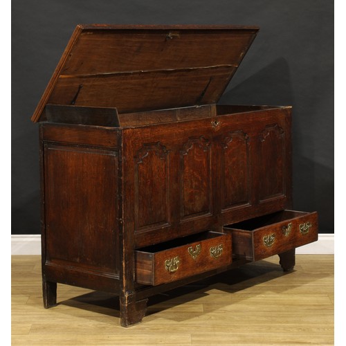 1897 - A George III oak mule chest, hinged top enclosing a till and two small drawers, the front with four ... 