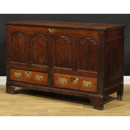 1897 - A George III oak mule chest, hinged top enclosing a till and two small drawers, the front with four ... 