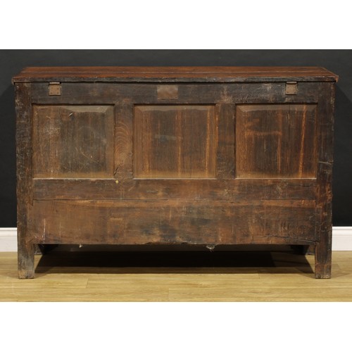 1897 - A George III oak mule chest, hinged top enclosing a till and two small drawers, the front with four ... 