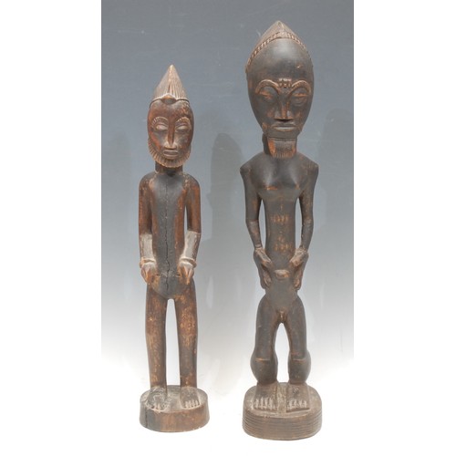 1431 - Tribal Art - a Baule figure, depicted standing, his hands to his slender midriff, 50cm high, Ivory C... 