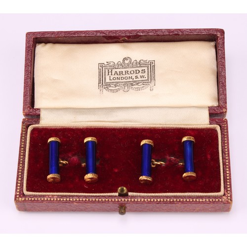 614 - A pair of 18ct gold and blue enamel cylindrical bar cufflinks, terminating in bright star cut caps, ... 