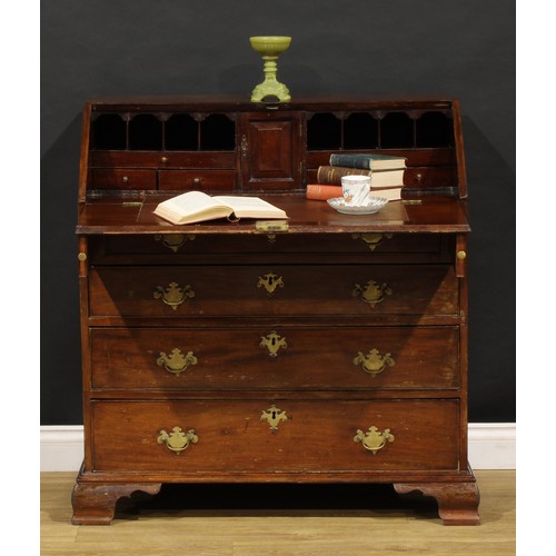 1737 - A George III mahogany bureau, fall front enclosing a small door, small drawers and pigeonholes, abov... 