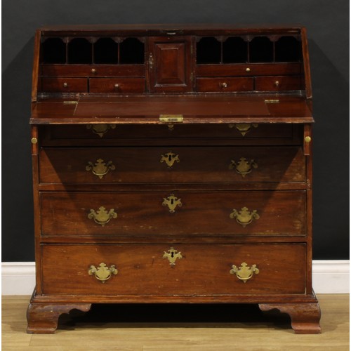 1737 - A George III mahogany bureau, fall front enclosing a small door, small drawers and pigeonholes, abov... 