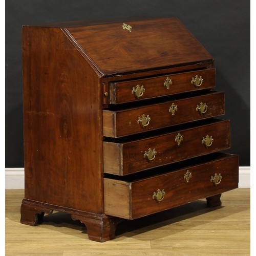 1737 - A George III mahogany bureau, fall front enclosing a small door, small drawers and pigeonholes, abov... 