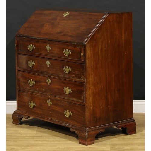 1737 - A George III mahogany bureau, fall front enclosing a small door, small drawers and pigeonholes, abov... 