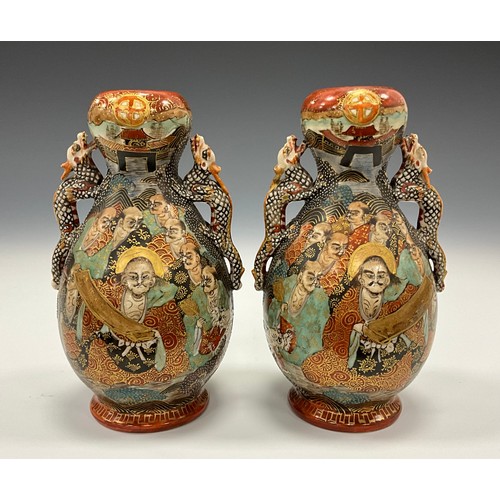 1222 - A pair of Japanese Satsuma Pottery baluster vases, each painted with Immortals and dragon, dragon mo... 