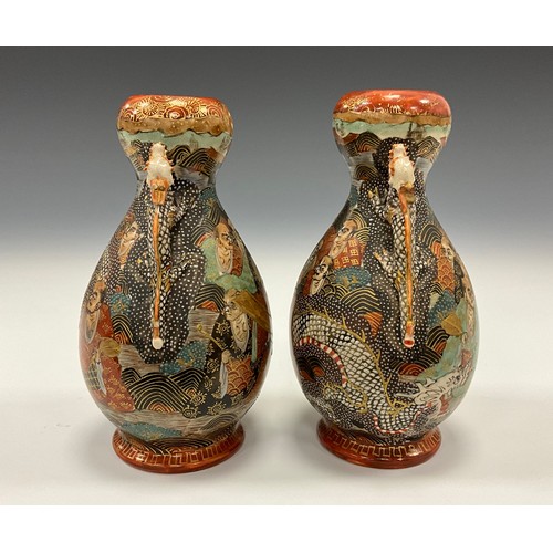 1222 - A pair of Japanese Satsuma Pottery baluster vases, each painted with Immortals and dragon, dragon mo... 