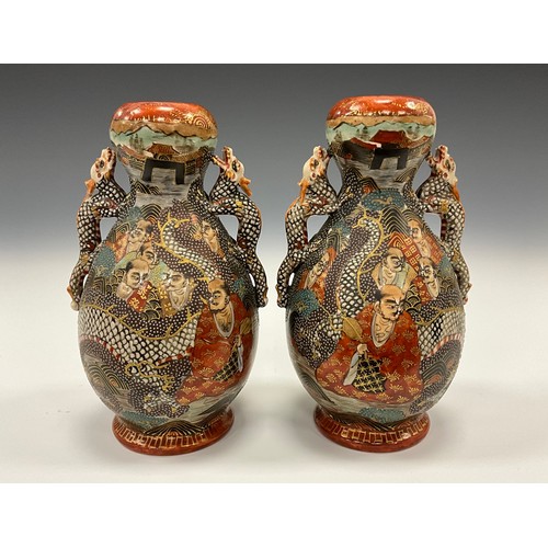 1222 - A pair of Japanese Satsuma Pottery baluster vases, each painted with Immortals and dragon, dragon mo... 