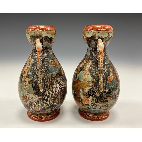 1222 - A pair of Japanese Satsuma Pottery baluster vases, each painted with Immortals and dragon, dragon mo... 