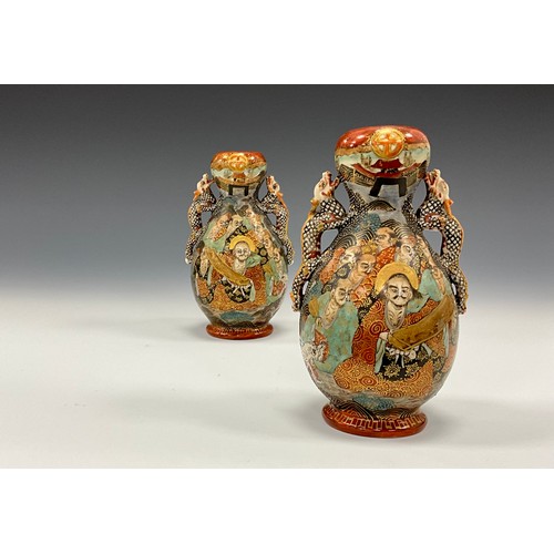 1222 - A pair of Japanese Satsuma Pottery baluster vases, each painted with Immortals and dragon, dragon mo... 