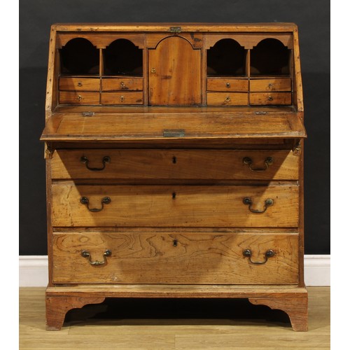 1730 - A George III elm bureau, fall front enclosing a fitted interior, above four long graduated drawers, ... 