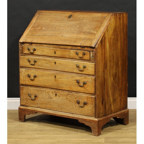 1730 - A George III elm bureau, fall front enclosing a fitted interior, above four long graduated drawers, ... 