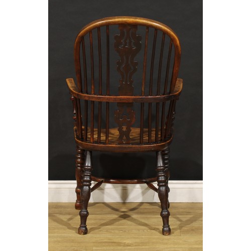 1677 - A 19th century yew and elm Windsor elbow chair, hoop back, unusual splat shaped and pierced with a h... 