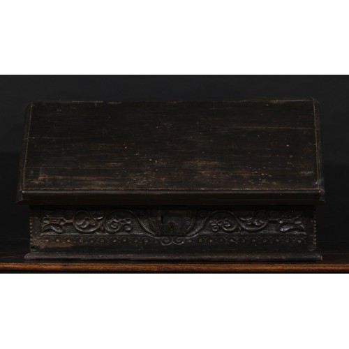 1524 - A 17th century and later oak table box, hinged sloping cover enclosing three small drawers, carved w... 