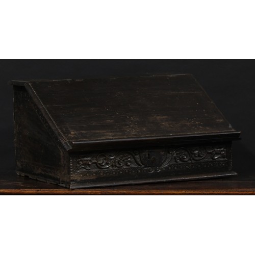 1524 - A 17th century and later oak table box, hinged sloping cover enclosing three small drawers, carved w... 