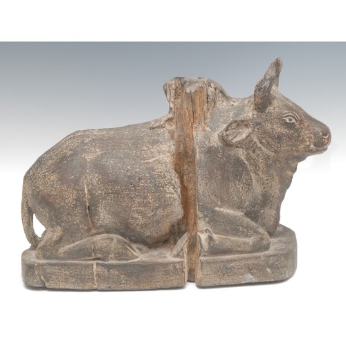 1888 - An Indian softwood carving, of a Nandi bull lodged, in the Hindu manner, 28cm high, 38cm long