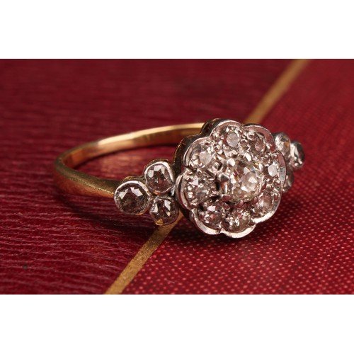 527 - A 19th century diamond ring, central nine stone daisy head between three stone set shoulders, total ... 