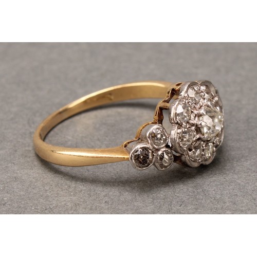 527 - A 19th century diamond ring, central nine stone daisy head between three stone set shoulders, total ... 