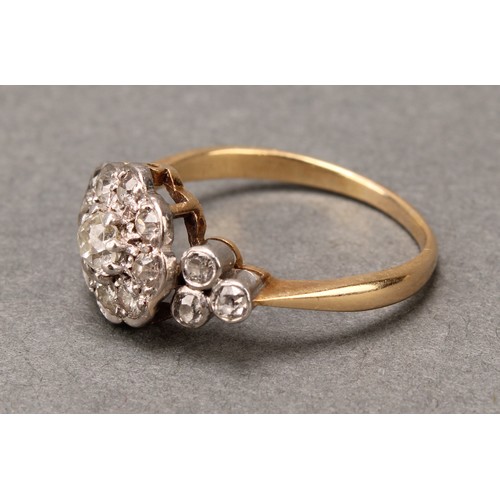 527 - A 19th century diamond ring, central nine stone daisy head between three stone set shoulders, total ... 