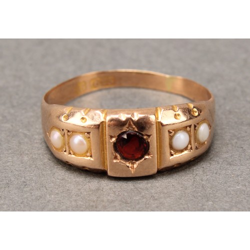 667 - A Victorian red garnet and half pearl ring, central red round cut garnet, between half pearl shoulde... 