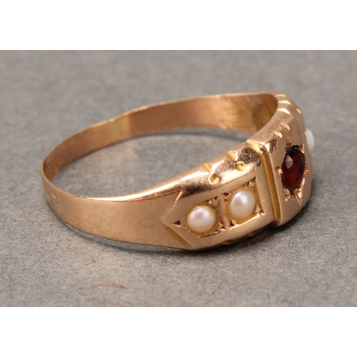 667 - A Victorian red garnet and half pearl ring, central red round cut garnet, between half pearl shoulde... 