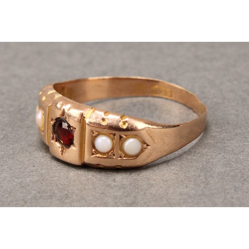 667 - A Victorian red garnet and half pearl ring, central red round cut garnet, between half pearl shoulde... 