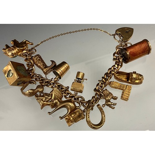 537 - A 9ct gold charm bracelet, pad lock clasp, suspending fifteen assorted charms, including elephant, c... 