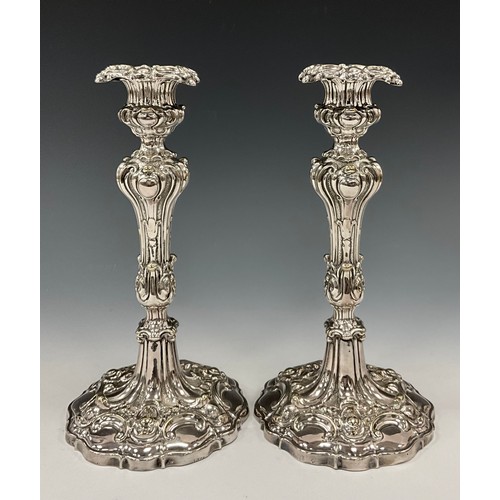 40 - A pair of Victorian Rococo Revival Sheffield silver plated candlesticks, weighted bases, 25.5cm high... 