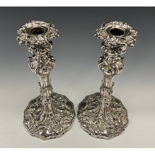 40 - A pair of Victorian Rococo Revival Sheffield silver plated candlesticks, weighted bases, 25.5cm high... 