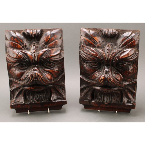 1848 - A pair of 19th century oak corbels or bosses, boldly carved with Green Man foliate masks, 28cm long,... 