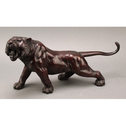 1401 - Japanese School (Meiji period), a pair of two-tone brown patinated bronzes, of tigers, prowling, sig... 