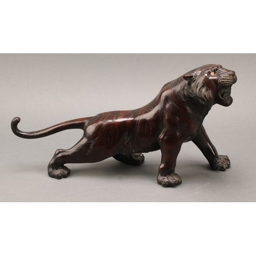 1401 - Japanese School (Meiji period), a pair of two-tone brown patinated bronzes, of tigers, prowling, sig... 