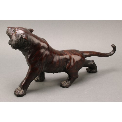 1401 - Japanese School (Meiji period), a pair of two-tone brown patinated bronzes, of tigers, prowling, sig... 