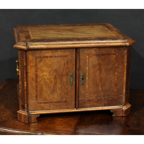 1802 - A 19th century mahogany table cabinet, slightly oversailing moulded herringbone crossbanded top abov... 