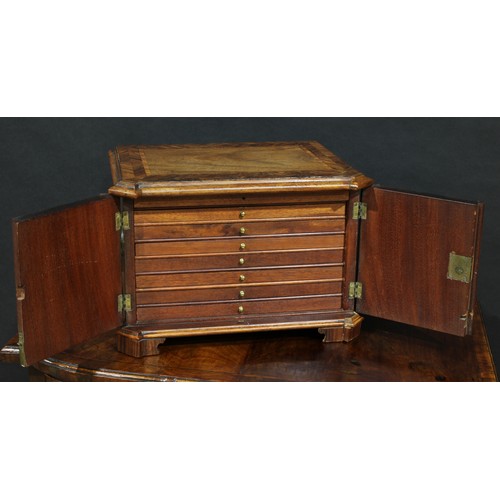 1802 - A 19th century mahogany table cabinet, slightly oversailing moulded herringbone crossbanded top abov... 