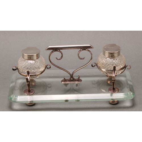 288 - An unusual late Victorian silver and clear glass inkstand, hobnail-cut globular wells, scroll handle... 