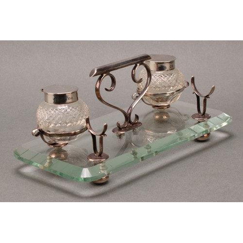 288 - An unusual late Victorian silver and clear glass inkstand, hobnail-cut globular wells, scroll handle... 