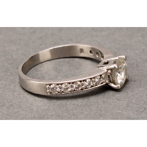 575 - A diamond ring, claw set brilliant cut stone flanked by two rows of five further stones, platinum sh... 